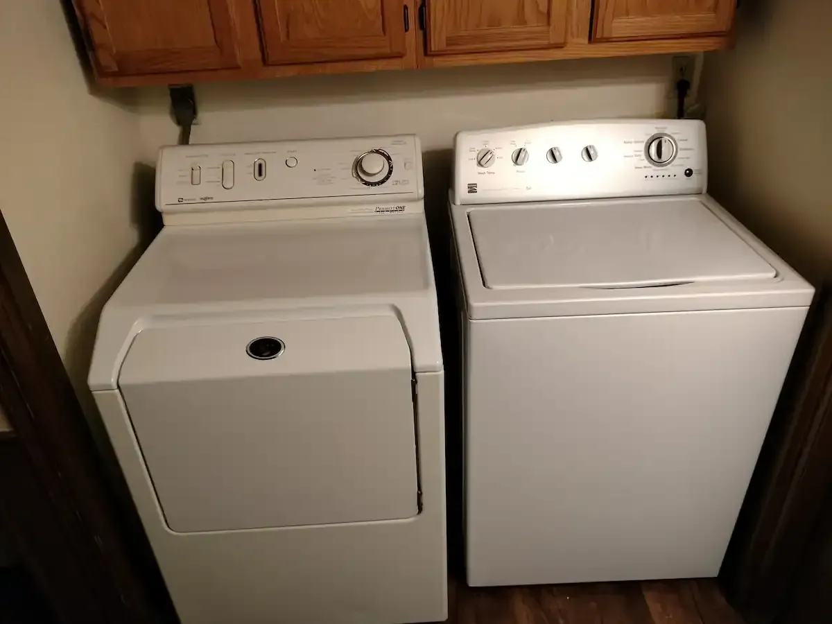 A washer and dryer are sitting next to each other in a laundry room.