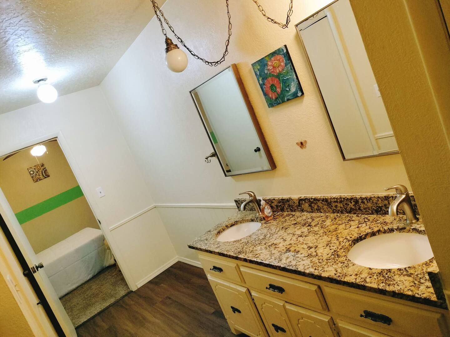 A bathroom with two sinks and a mirror