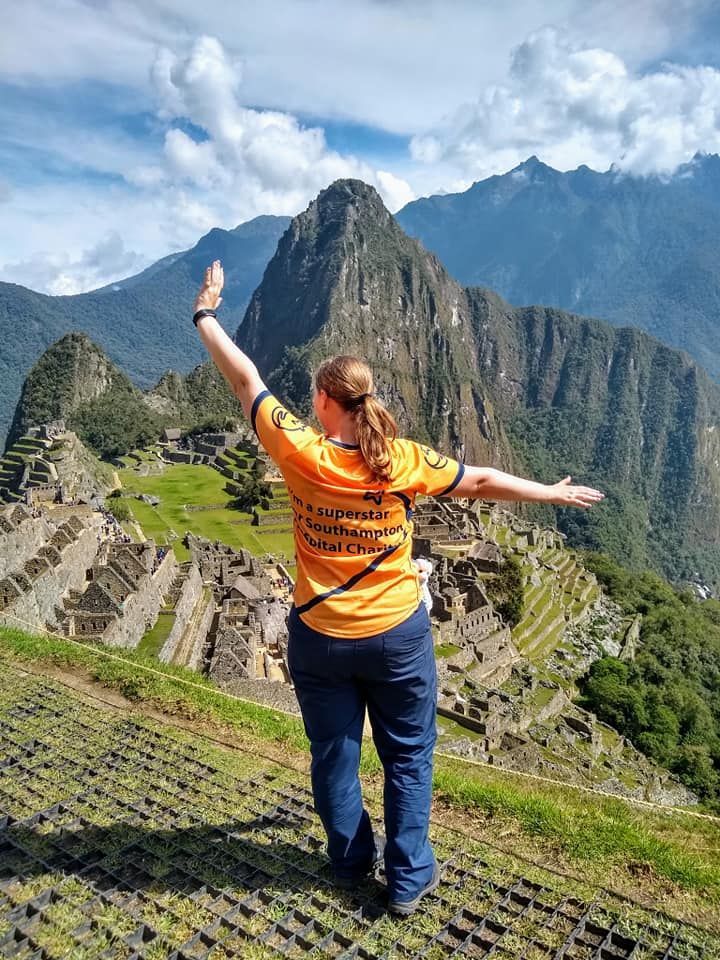 Back of someone standing in front of Machu Picchu Peru