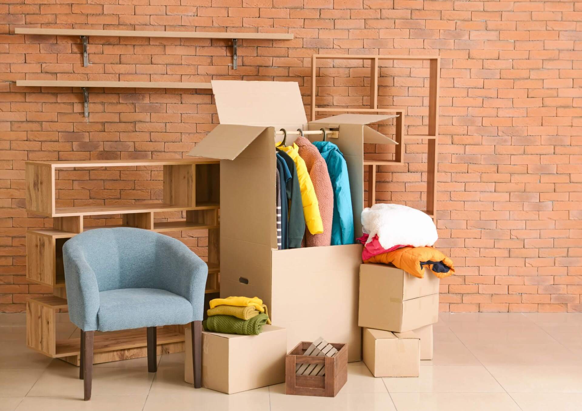 Moving boxes and furniture in a room with a brick wall