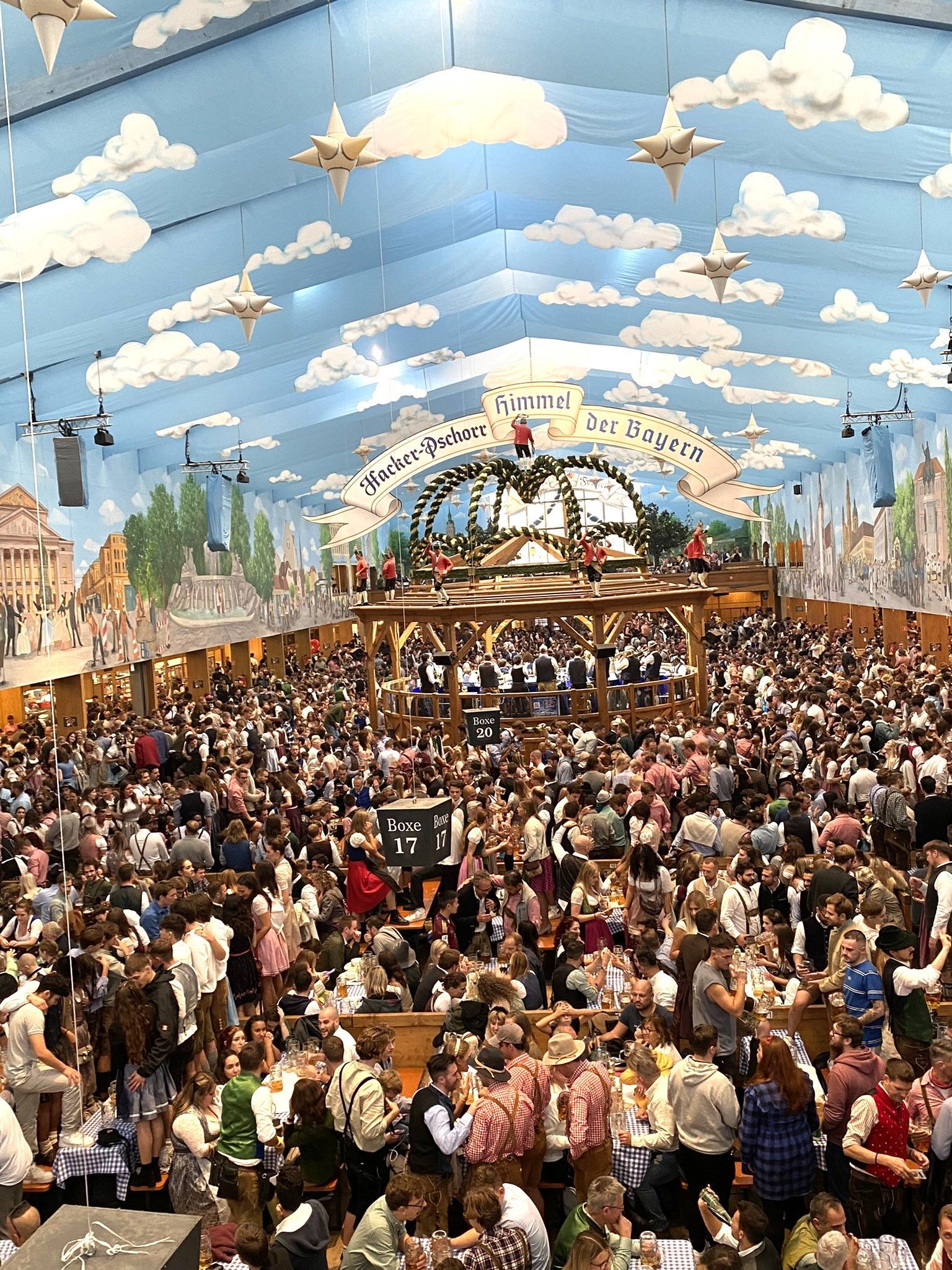 A man is standing in front of a sign that says gauboden volksfest straubing