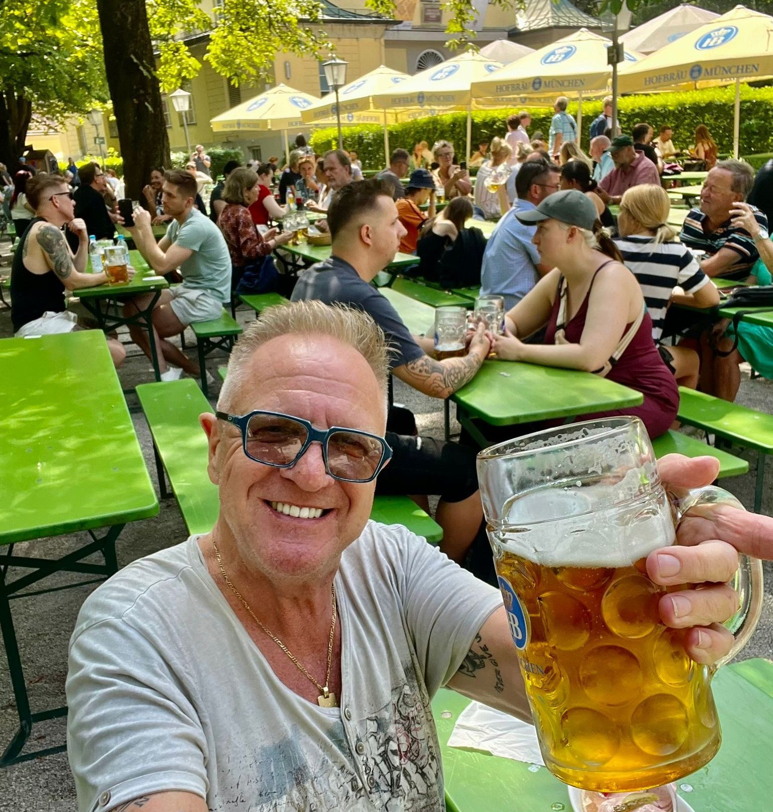 Two men wearing hats and glasses are posing for a picture together.