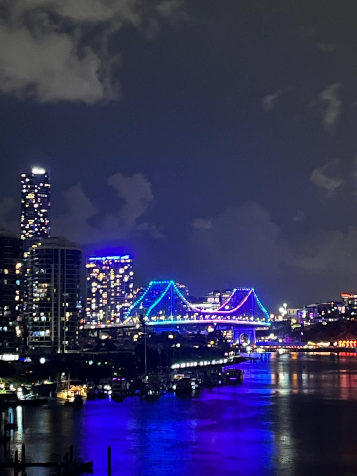 A bridge is lit up with blue lights at night