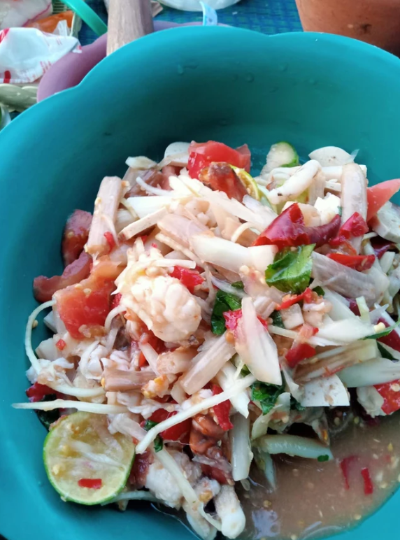 A close up of a salad in a blue bowl