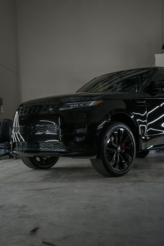 A black car is parked in a garage.