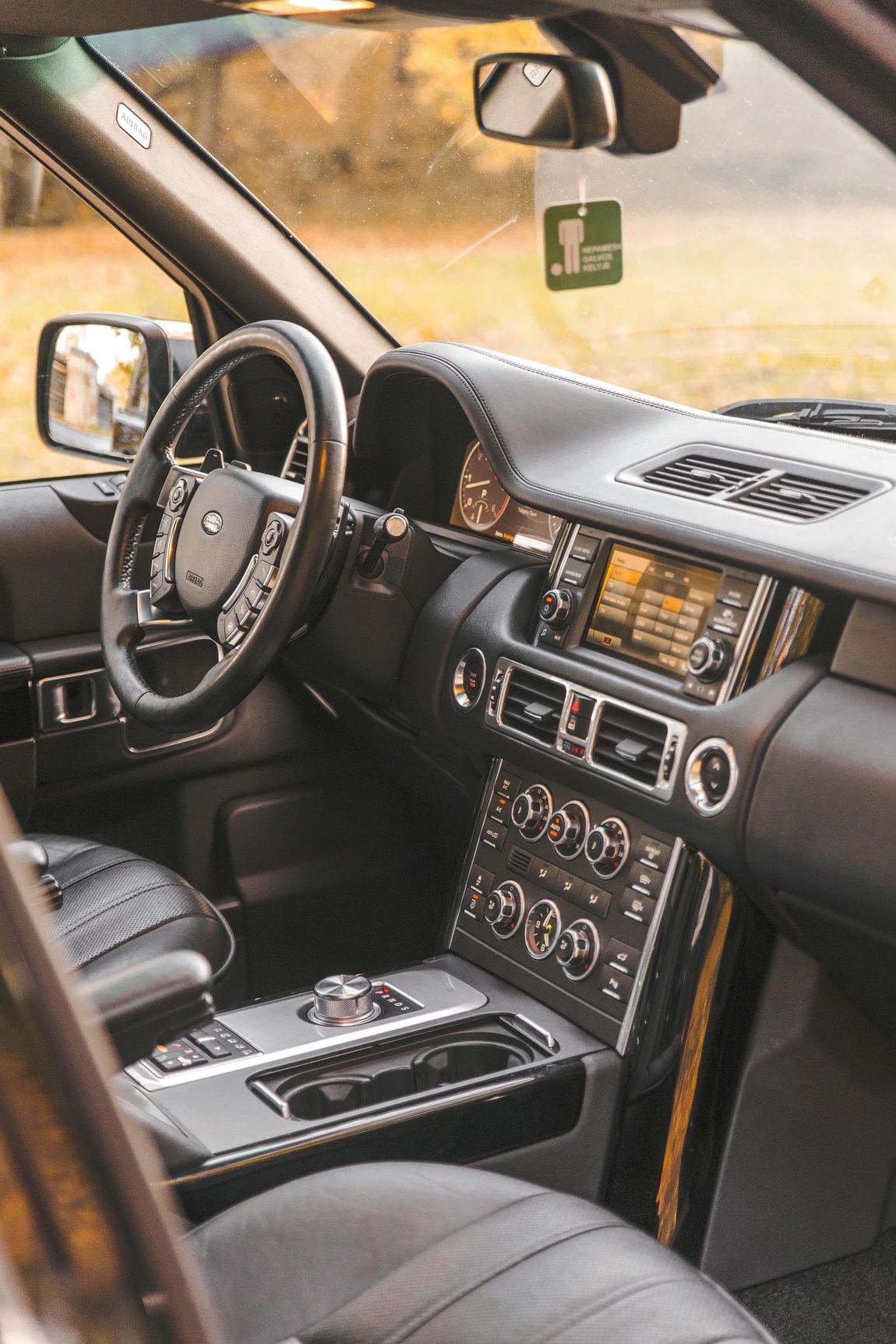 The interior of a range rover with a steering wheel and dashboard.