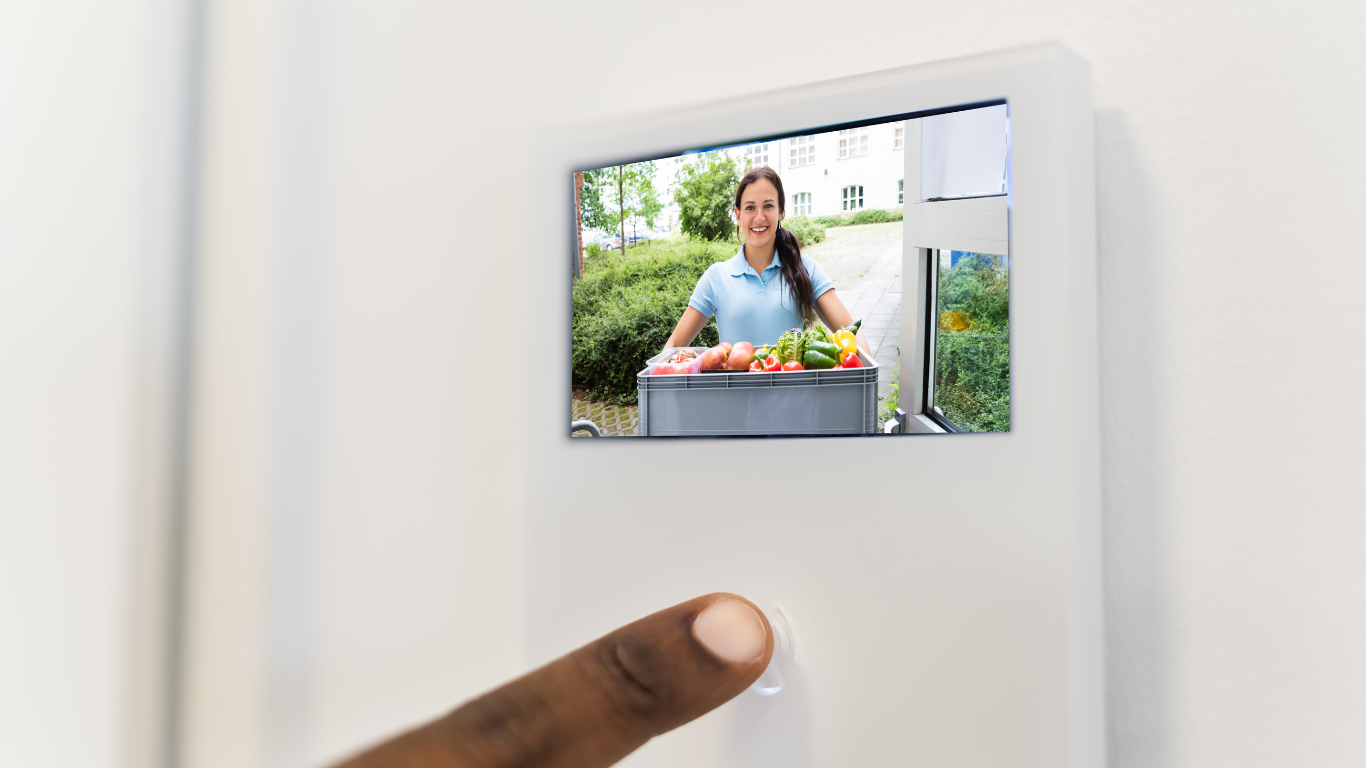 A person is pressing a button on an intercom system.