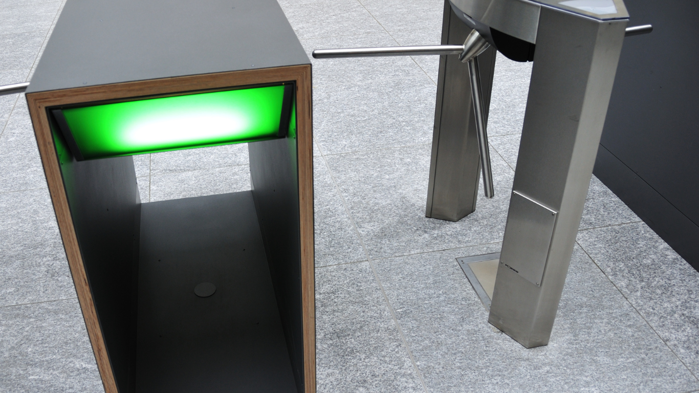 A security turnstile with a green light on it