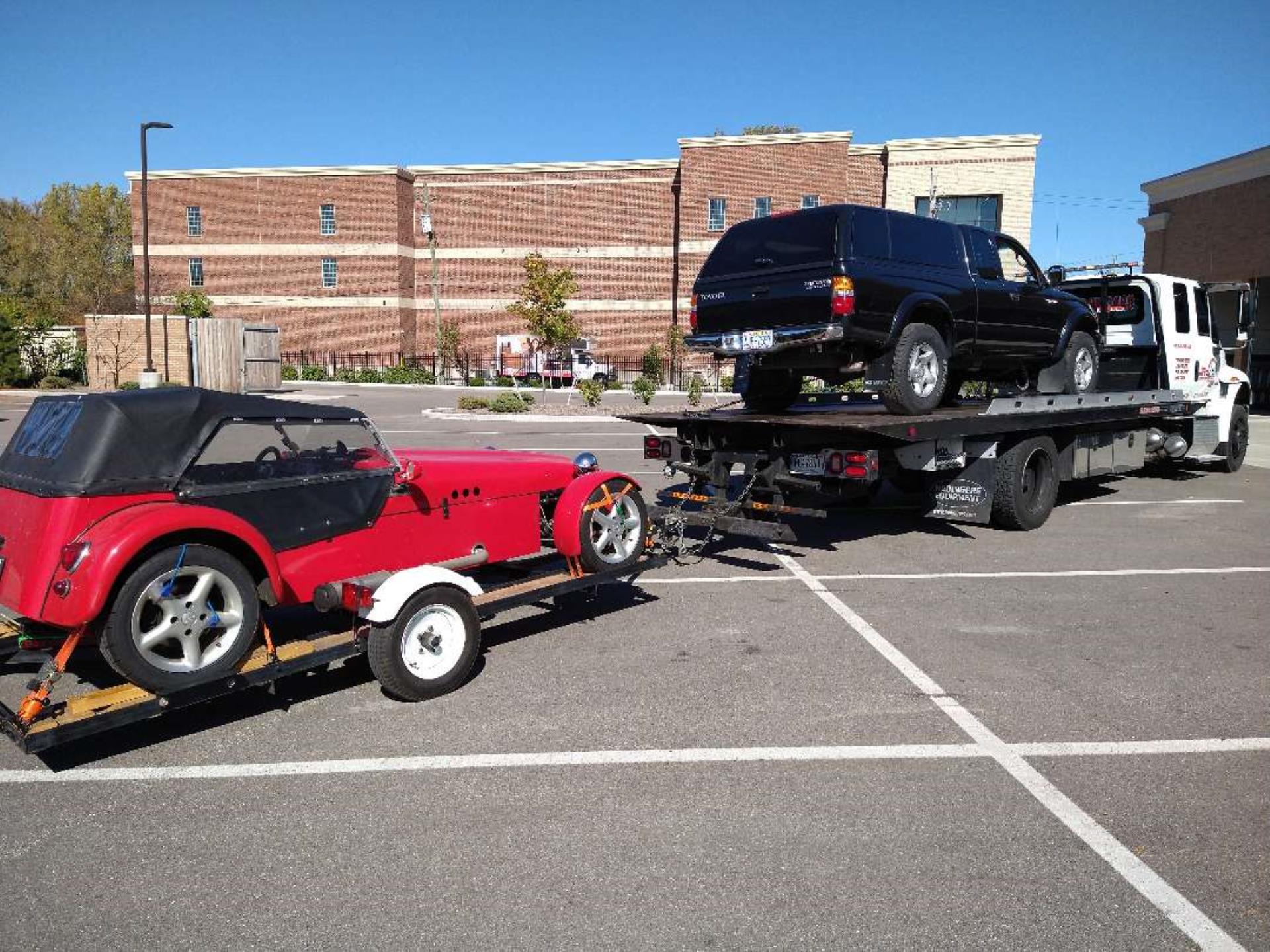 Flatbed Tow Truck Towing Two Cars In Indianapolis