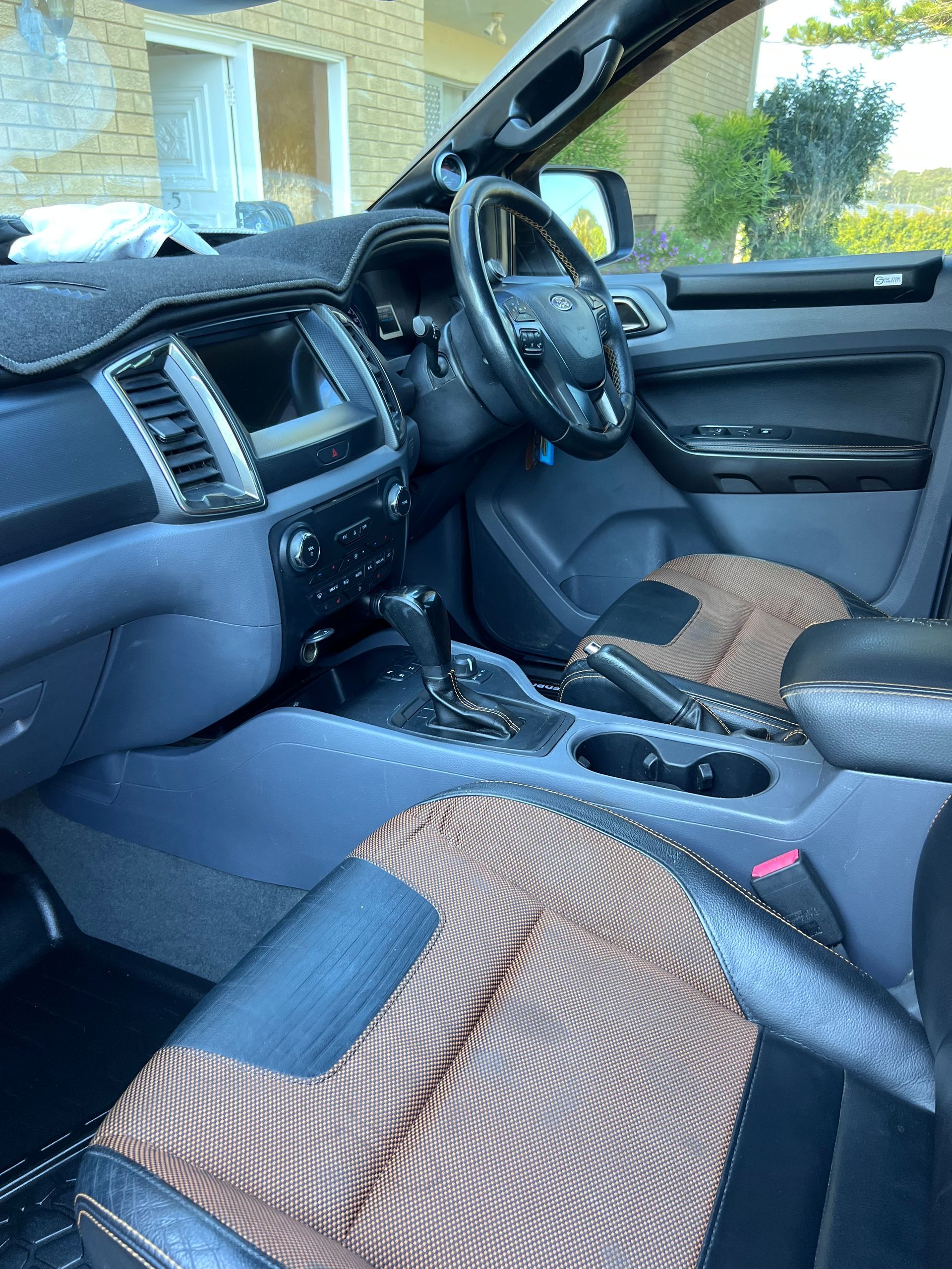 Car Interior With Black Dashboard And Patterned Front Seats, Viewed From The Passenger Side — Car Detailing Mobile Cleaning Co In Thrumster, NSW