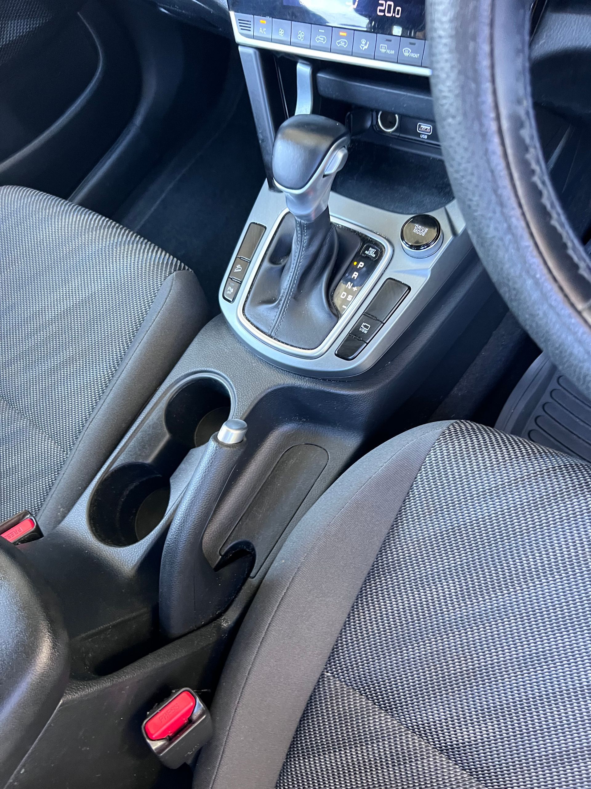 Car Interior Showing Center Console With Gear Shift, Cupholders, And Gray Cloth Seats — Car Detailing Mobile Cleaning Co In Wauchope, NSW