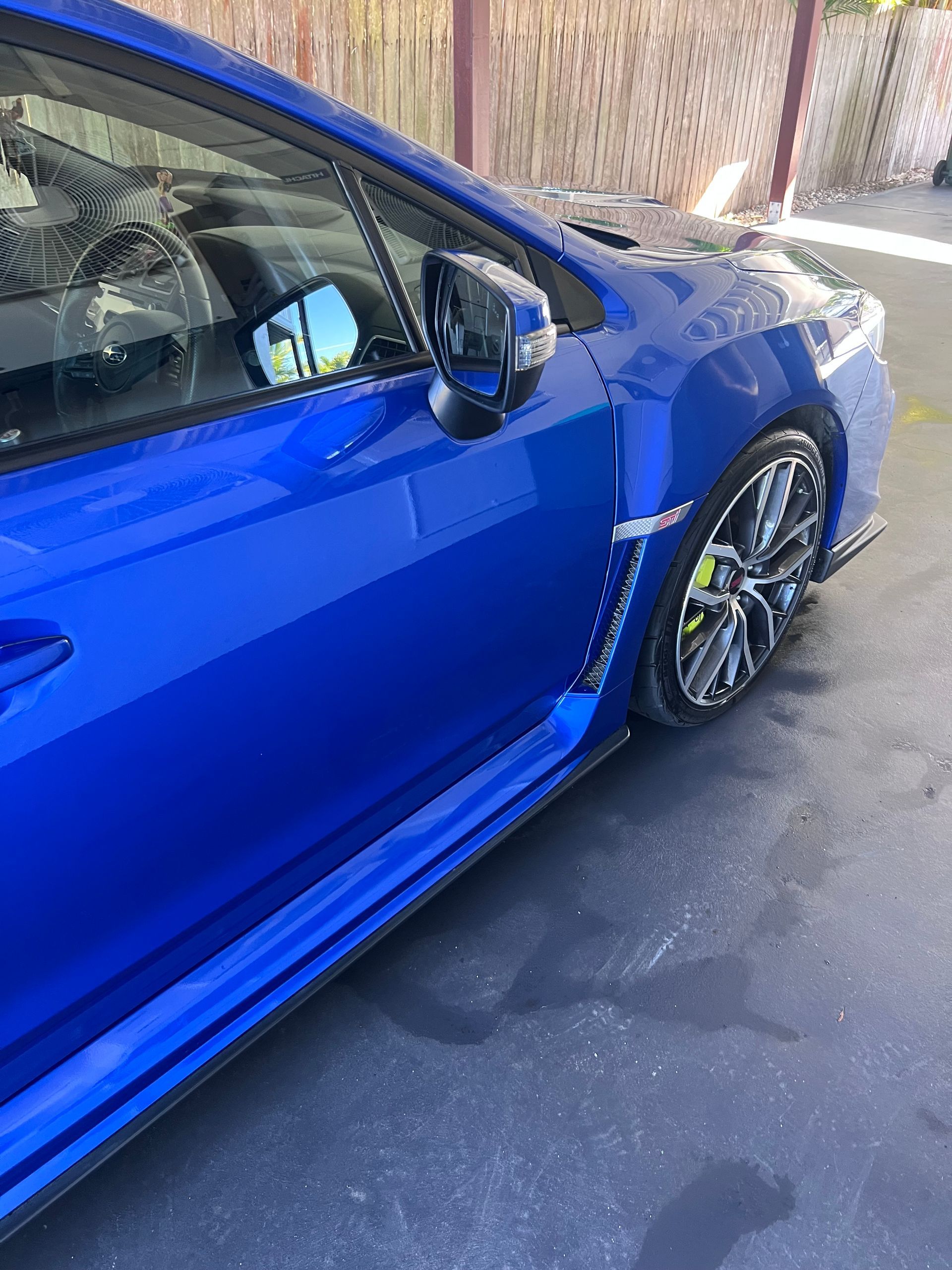 Blue Sports Car Parked On Pavement Beside A Wall, Shown From The Side And Front Wheel — Car Detailing Mobile Cleaning Co In Lake Cathie, NSW