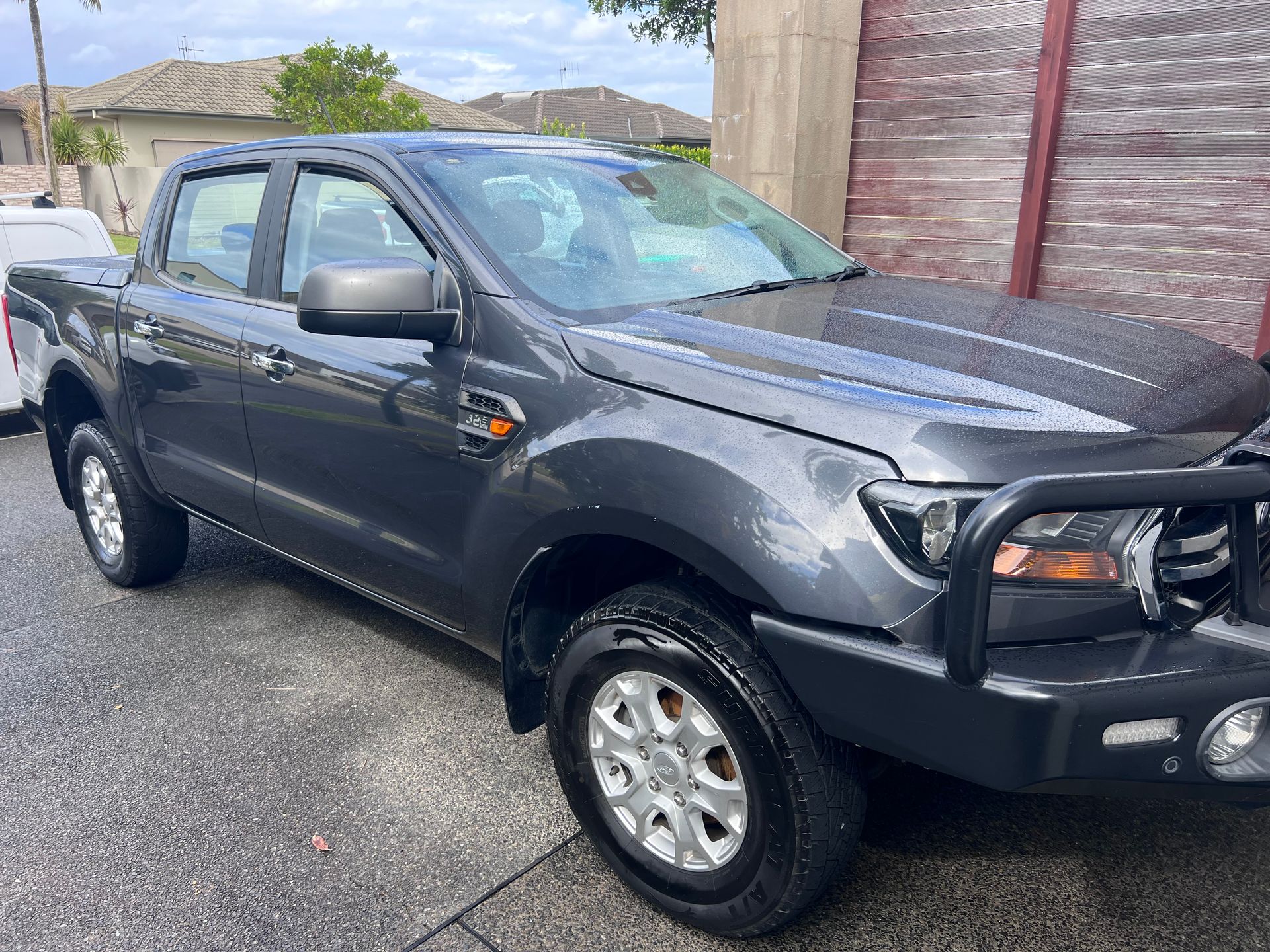 Gray Pickup Truck Parked On A Driveway Beside A Wooden Fence And Brick Wall — Car Detailing Mobile Cleaning Co In Thrumster, NSW