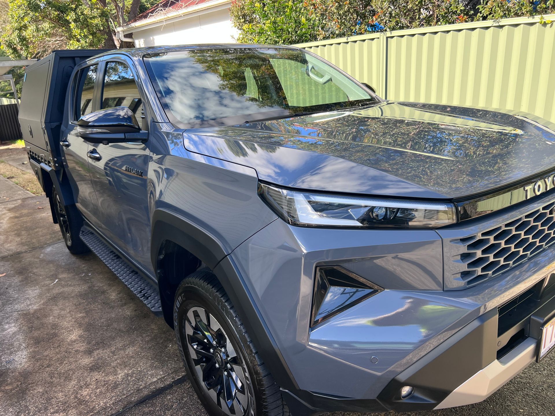 Gray Pickup Truck Parked In A Driveway Beside A Green Fence, Front-left View — Car Detailing Mobile Cleaning Co In Port Macquarie, NSW