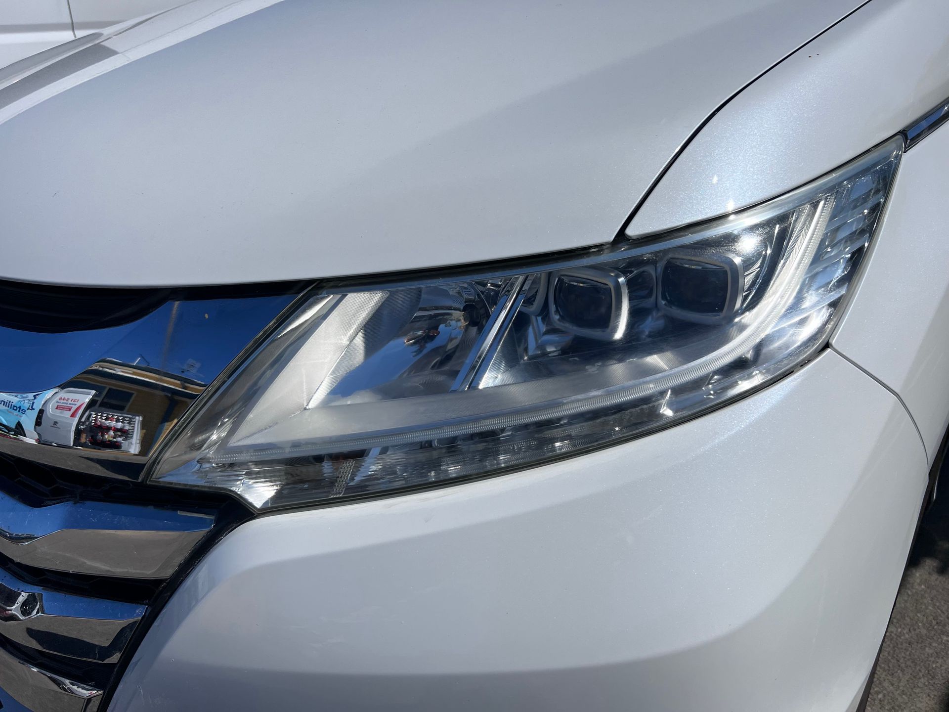 Close-up Of a Silver Car’s Front Headlight and Grille — Car Detailing Mobile Cleaning Co In Lake Cathie, NSW