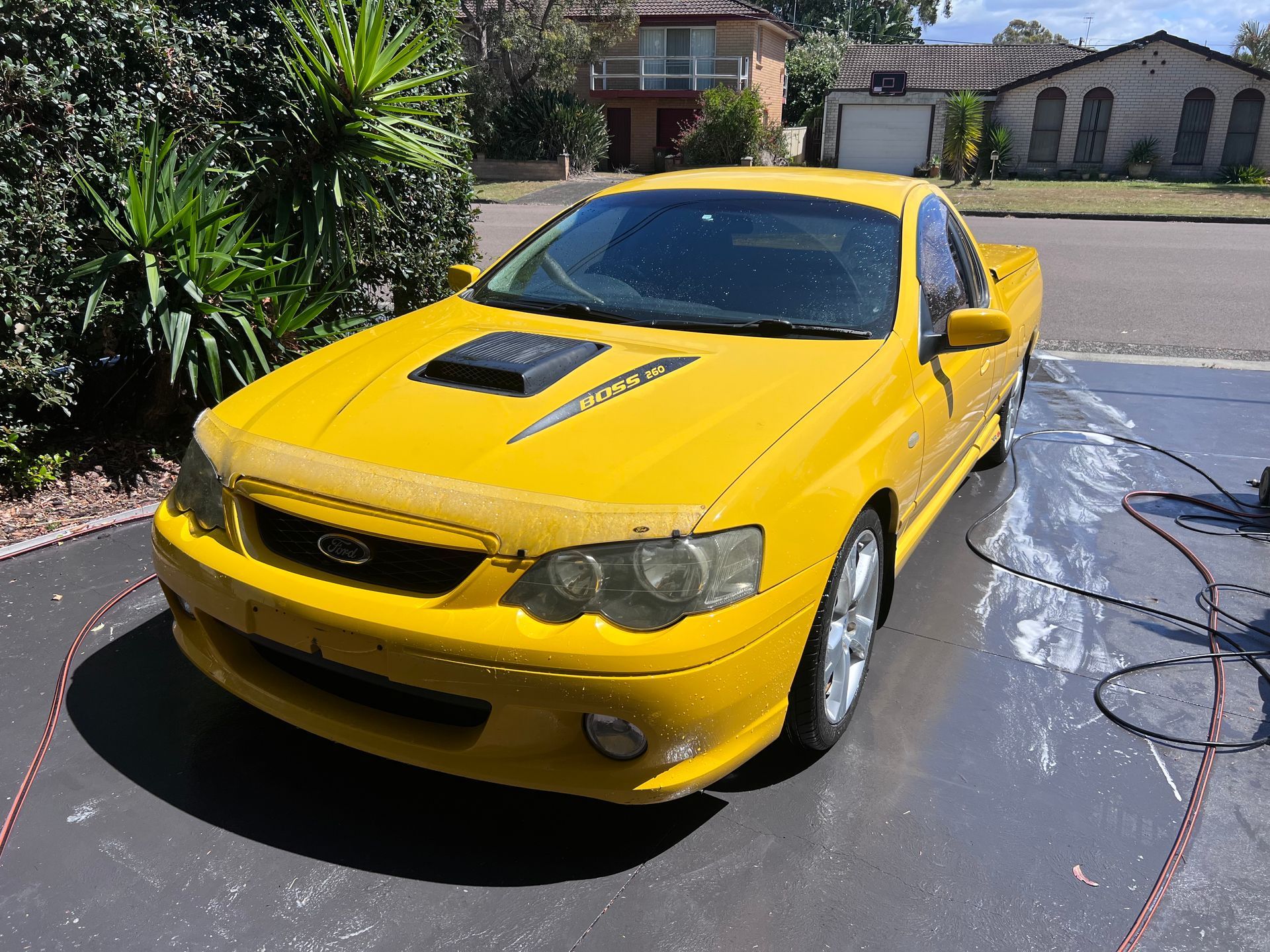 Yellow sports car parked in a driveway — Car Detailing Mobile Cleaning Co In Thrumster, NSW