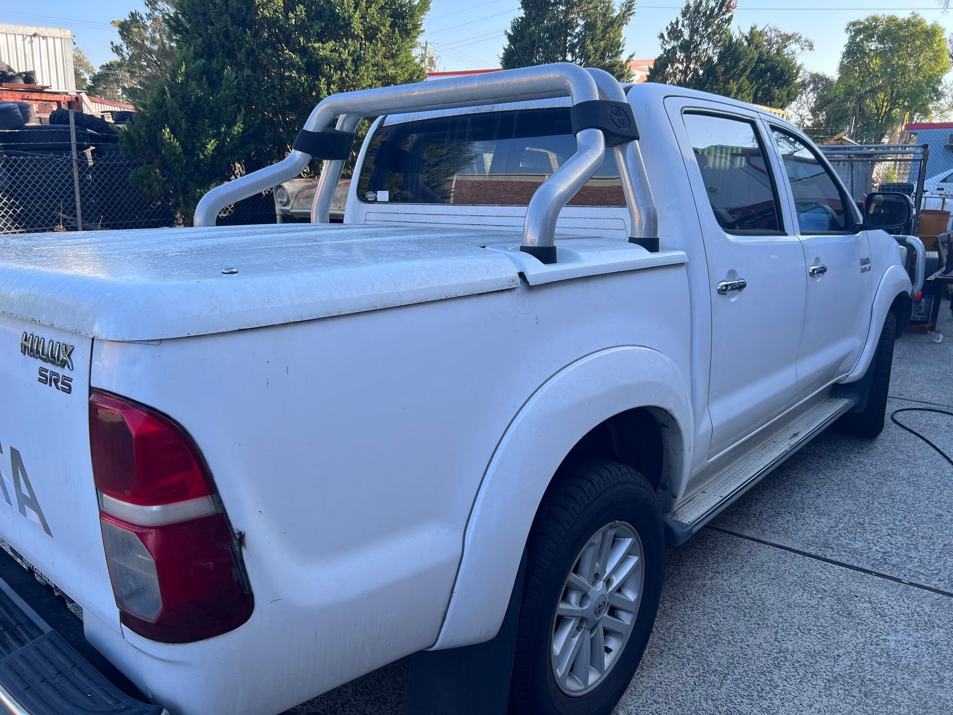 White Pickup Truck With Silver Roof Rack Parked on a Concrete Outdoors — Car Detailing Mobile Cleaning Co In Thrumster, NSW