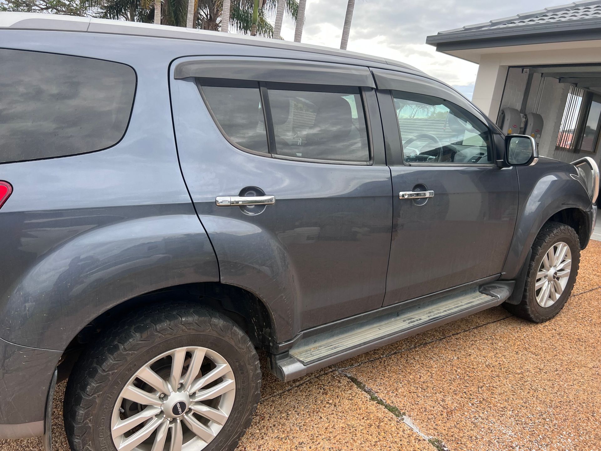 Grey SUV Parked on a Gravel Driveway Beside a House — Car Detailing Mobile Cleaning Co In Thrumster, NSW