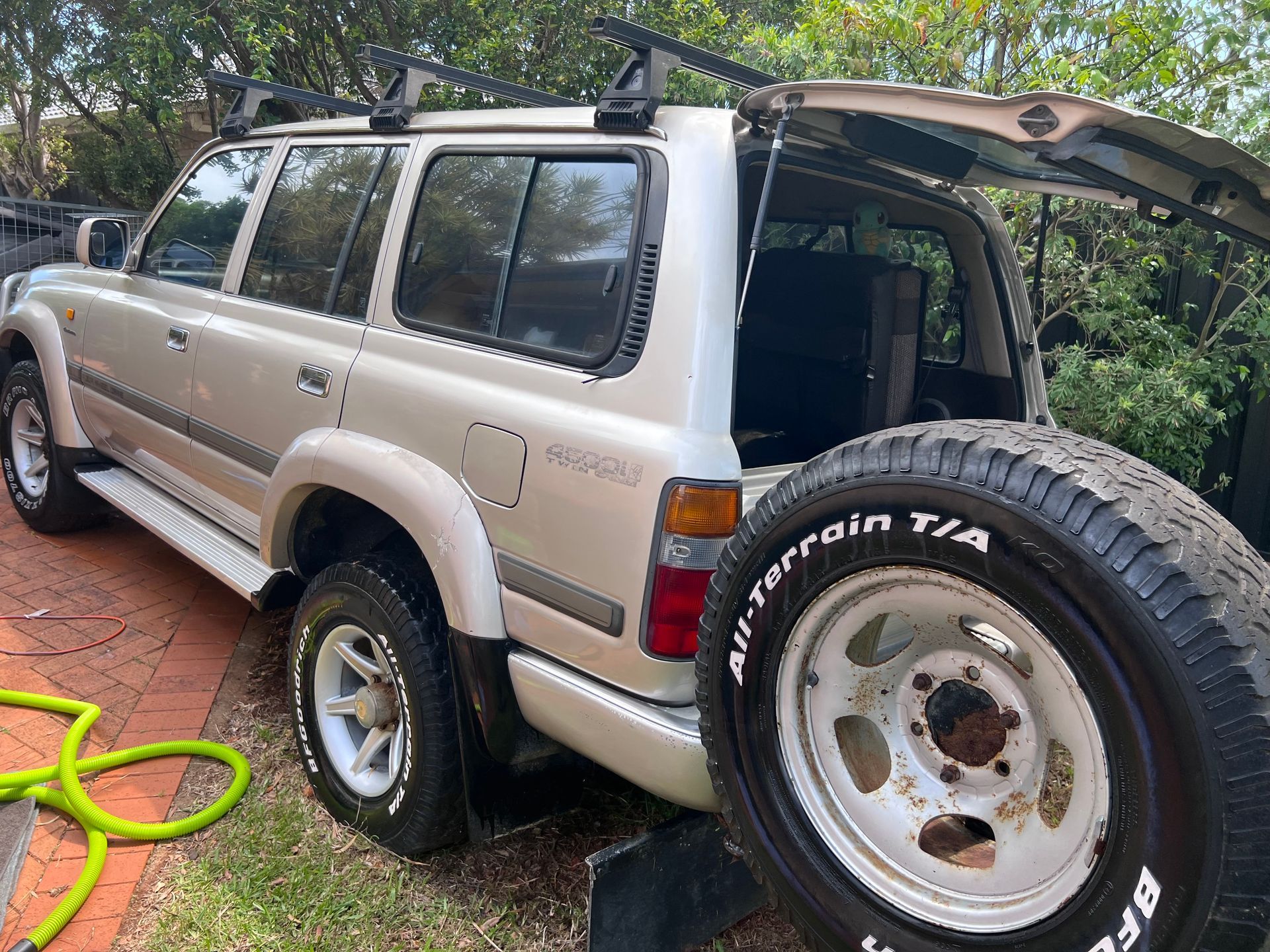 Silver SUV Parked On A Brick Driveway With Its Rear Hatch Open And A Spare Tire Mounted On The Back — Car Detailing Mobile Cleaning Co In Lake Cathie, NSW