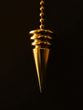Gold pendulum hanging against a black background.