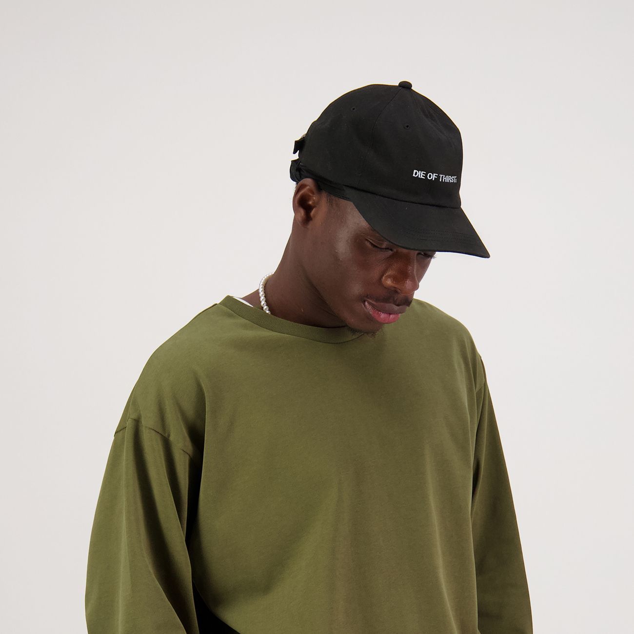 Black  baseball cap with white text: 