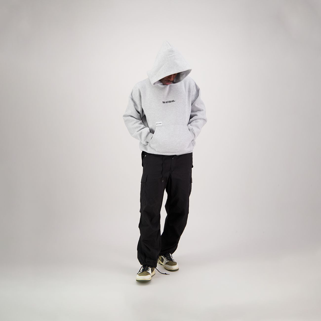 Gray hoodie with small logo on chest and pocket.