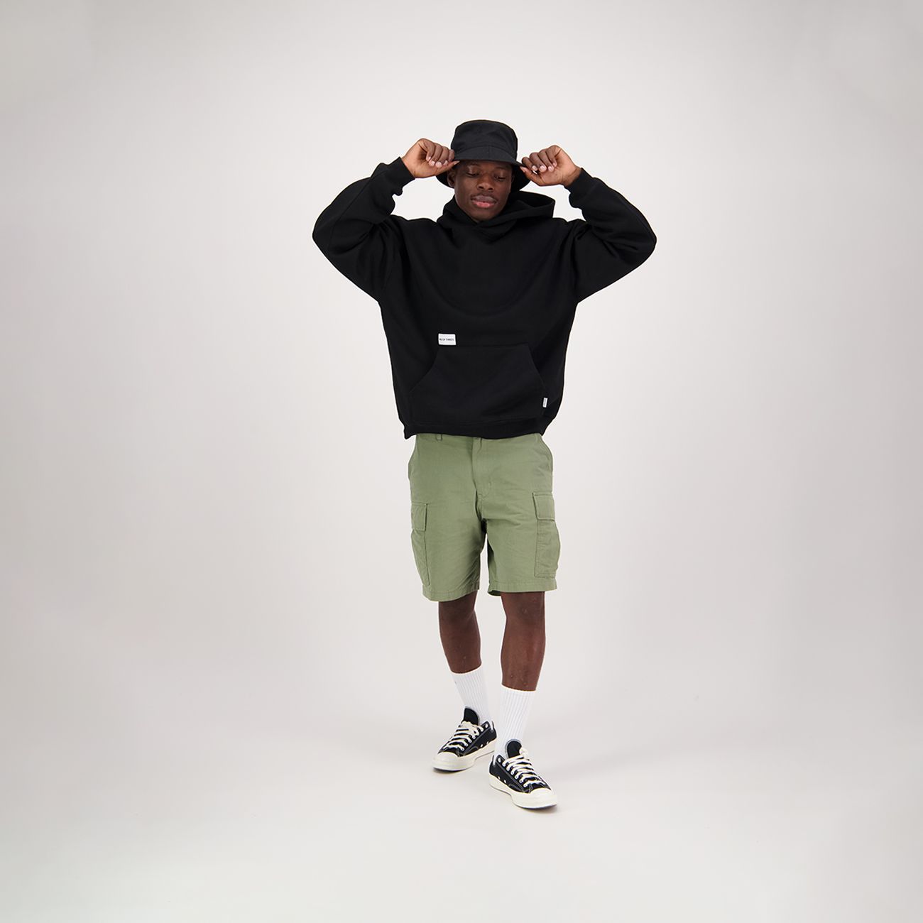 Black oversized hoodie with a hood and front pocket.