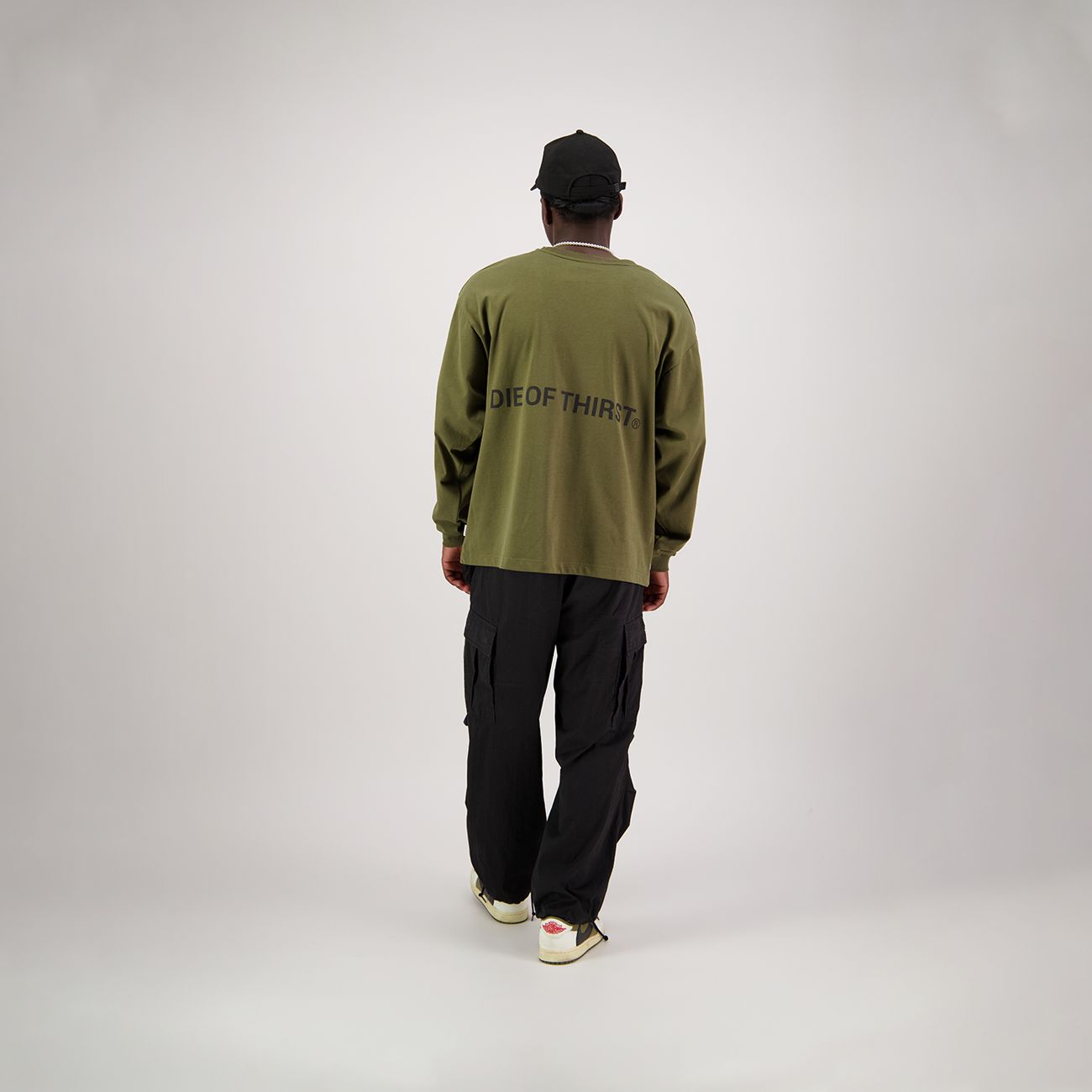 Olive green long-sleeved shirt with a crew neck and loose fit.