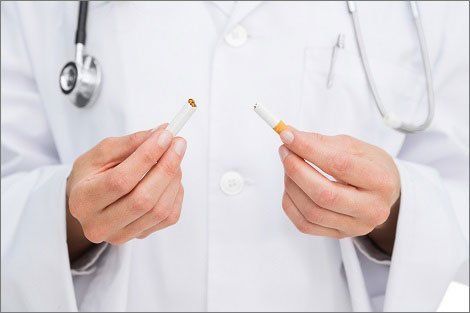 Doctor Holding a Broken Cigarette — Orange, CT — New England Dental Health Services PC