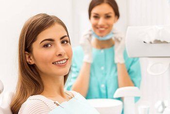 Smiling Woman and Dentist — Orange, CT — New England Dental Health Services PC