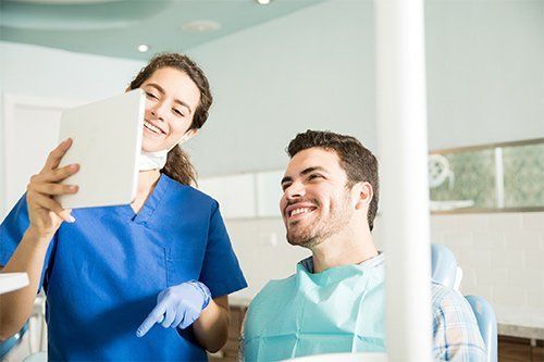 Dentist Showing Dental Result to Patient — Orange, CT — New England Dental Health Services PC