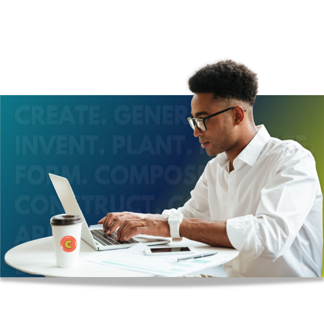 A man is sitting at a table using a laptop computer.