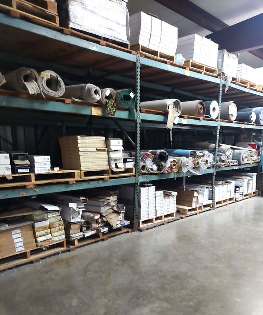 A warehouse filled with lots of rolls and boxes