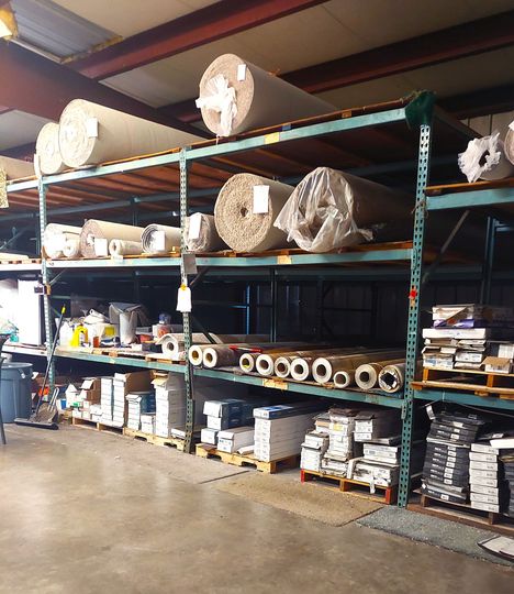 A warehouse filled with lots of rolls and boxes