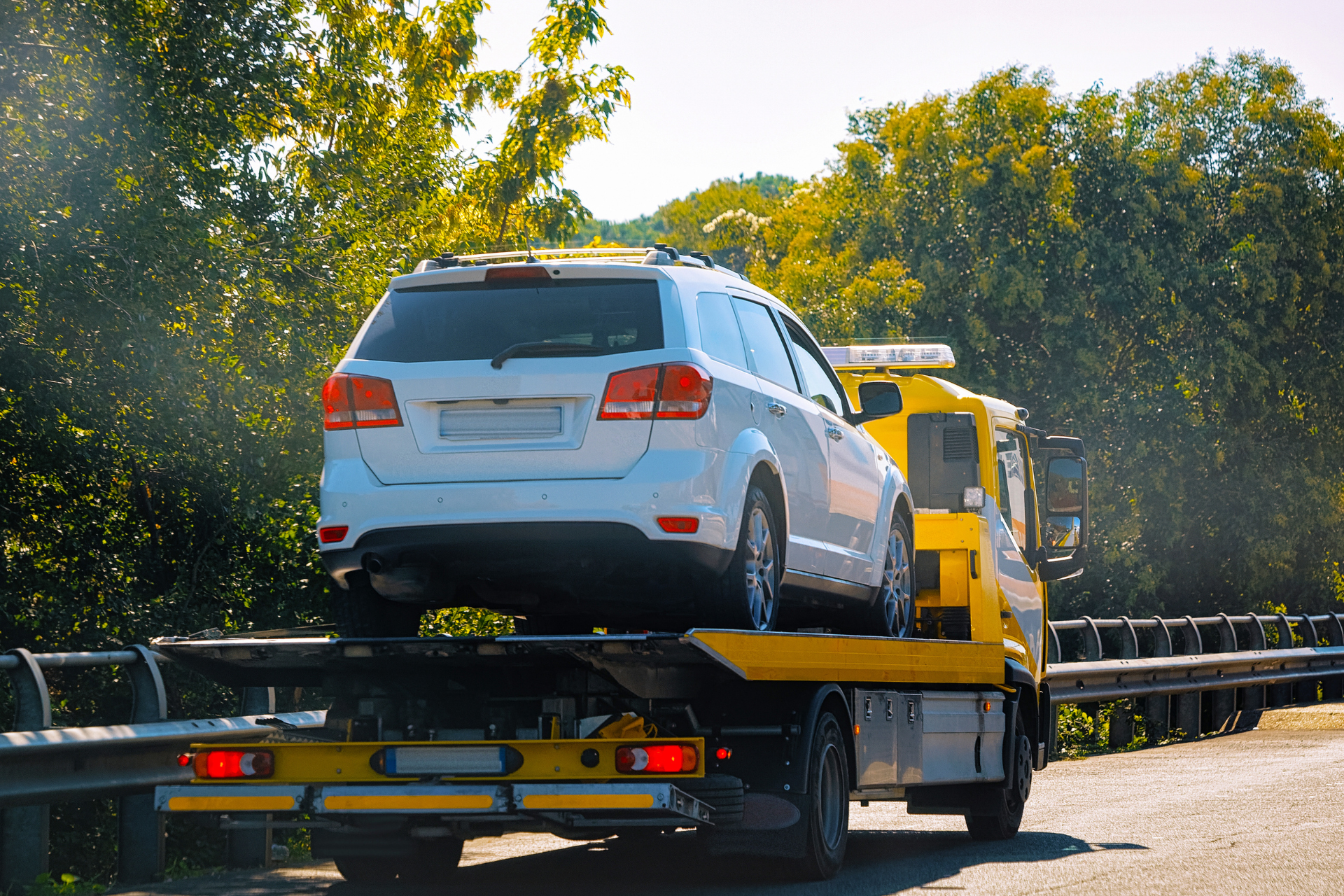 Tow Truck with Car on the Road