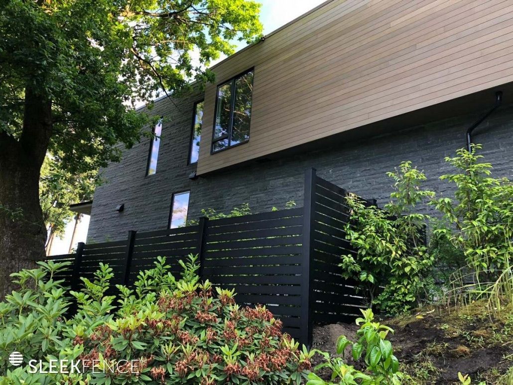 A house with a black fence in front of it