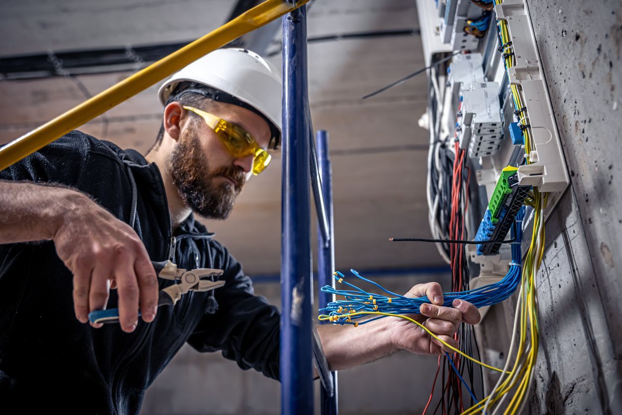 Certified electrician working on wiring in a home