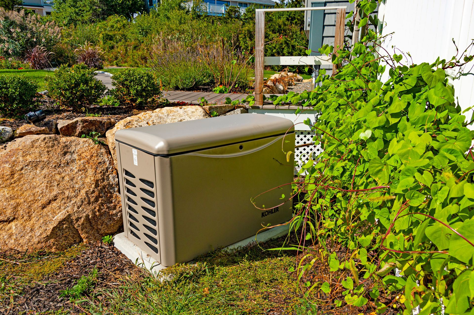 Whole-house generator installed outside a home to prevent summer power outage disruptions.
