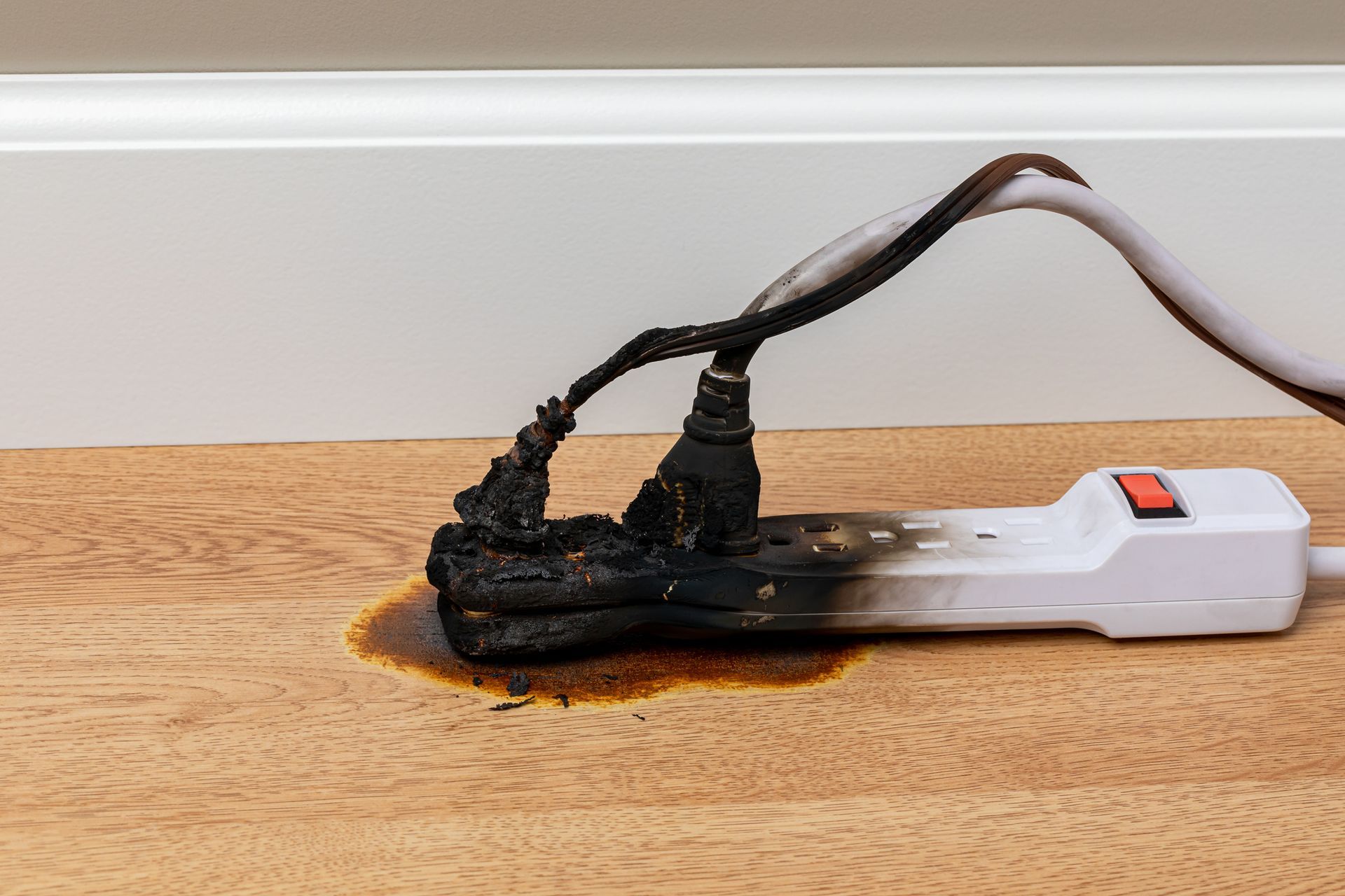 Electrical surge protector outlet and extension cord fire. Electricity safety and fire hazard.