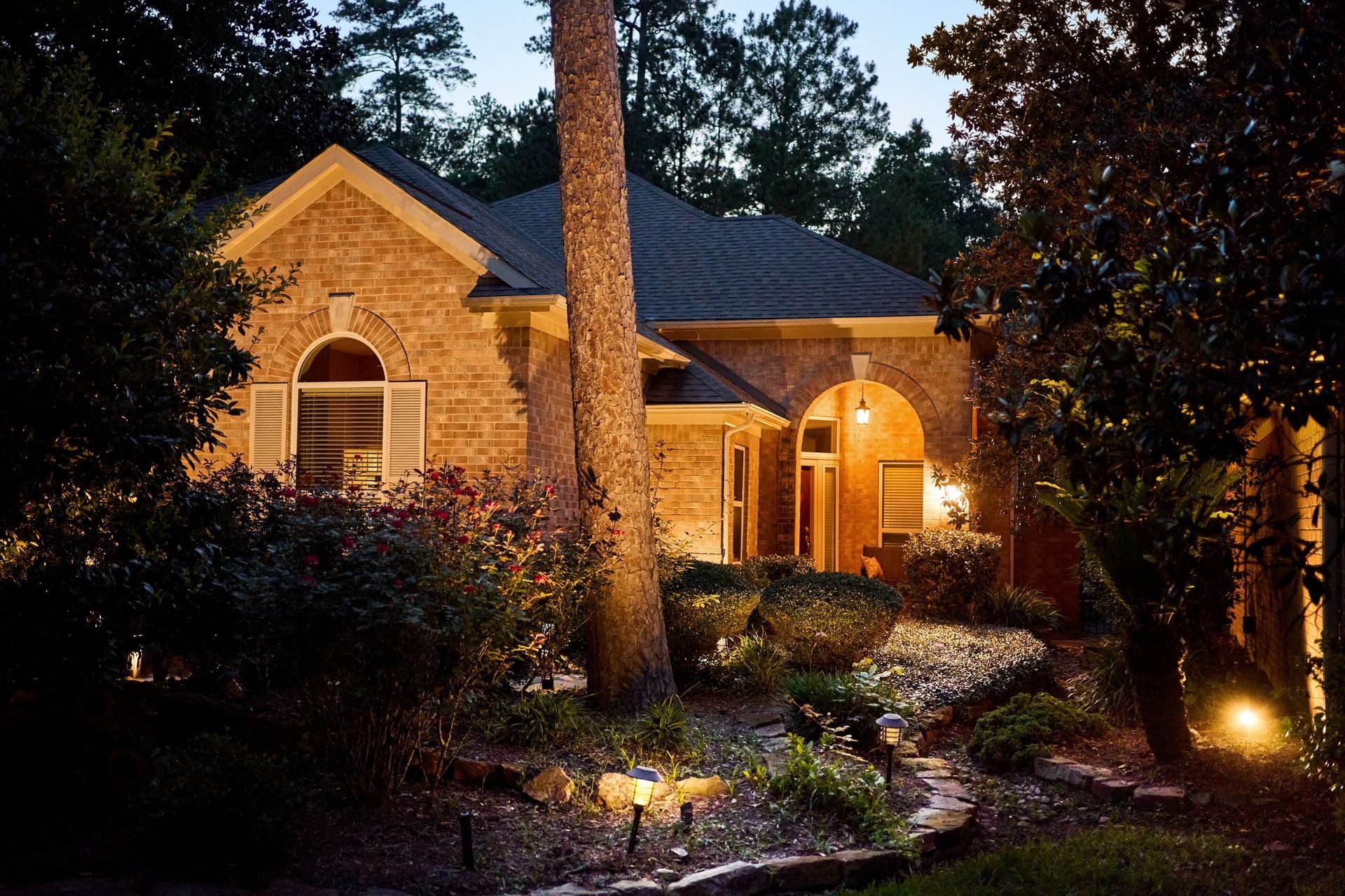 Beautifully illuminated luxury home with landscape and pathway lighting at night in Valencia PA.