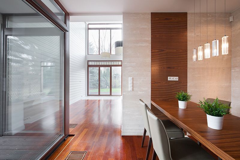 a dining room with a wooden table and chairs