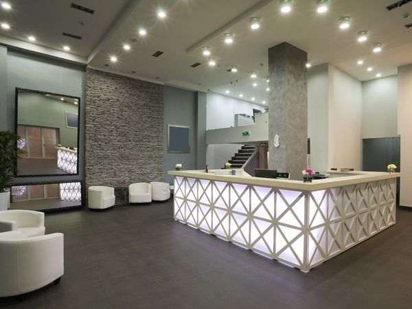 a large lobby with a reception desk and chairs