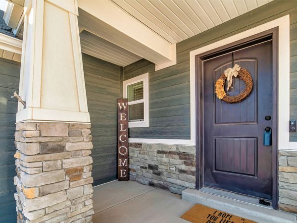 the front door of a house with a welcome sign on it .