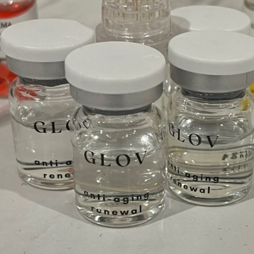 Several bottles of glov anti aging renewal are sitting on a table