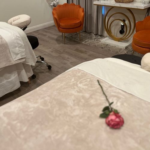 There is a rose on the bed in the middle of the room.