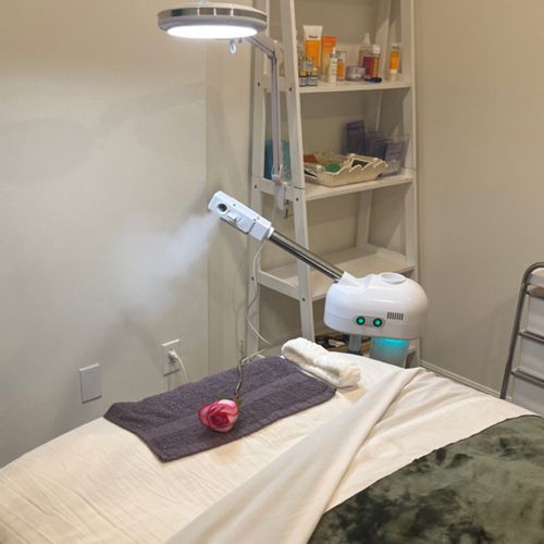 A bed with a towel and a lamp on it in a room.