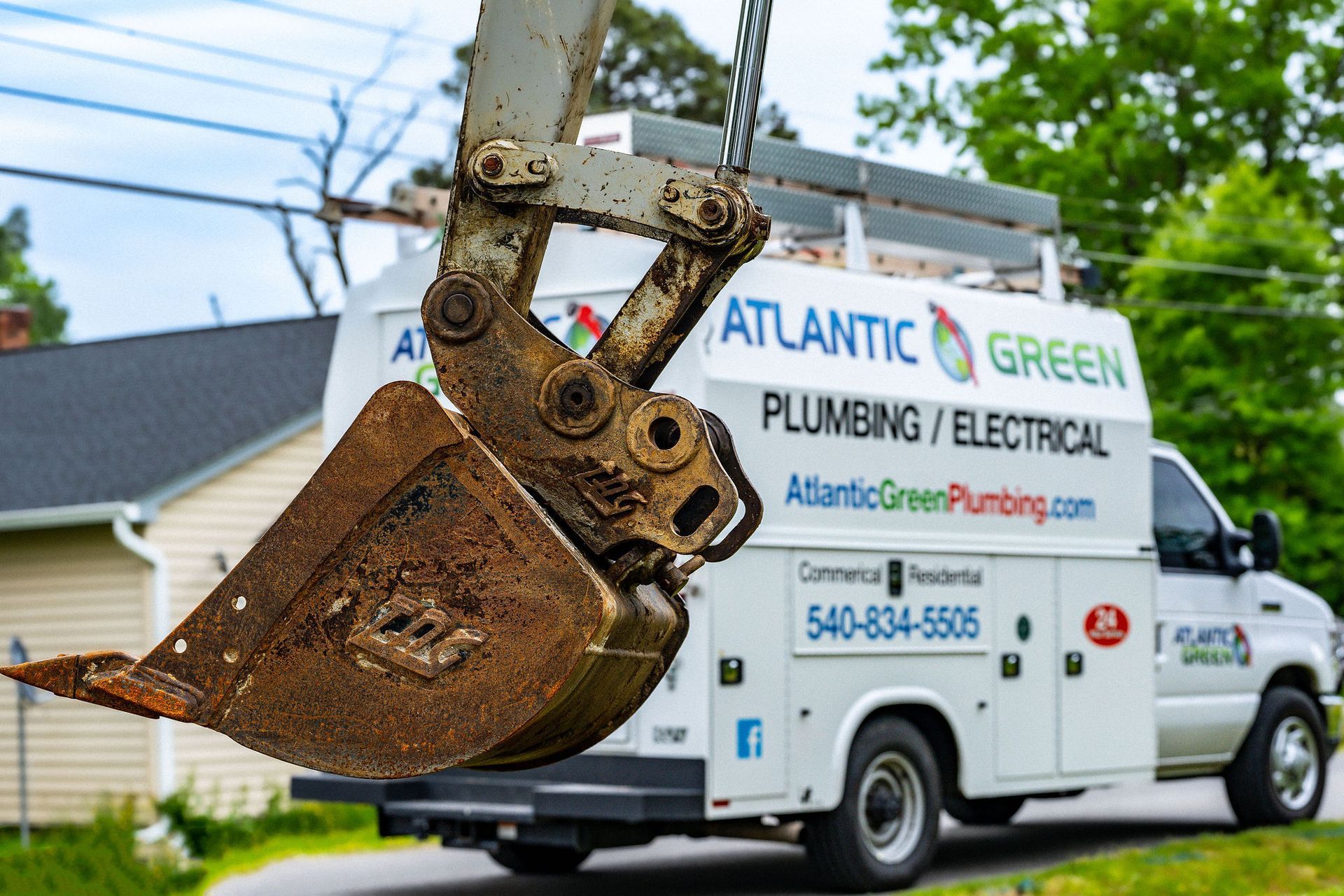 Commercial Plumber — Plumber Fixing the Water Heater in Fredericksburg, VA