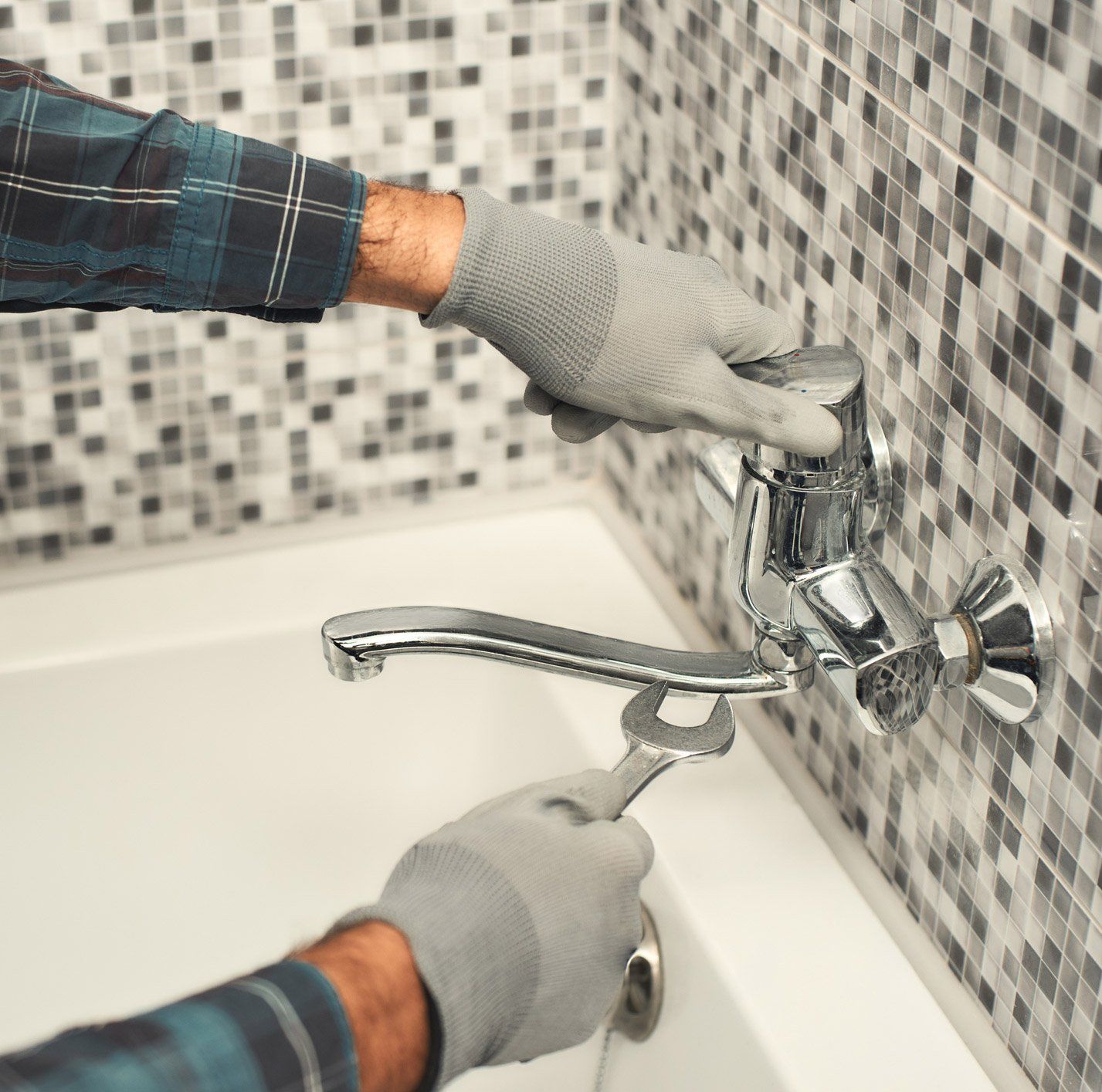 Bathroom Plumbing — Man Fixing the Faucet in Fredericksburg, VA