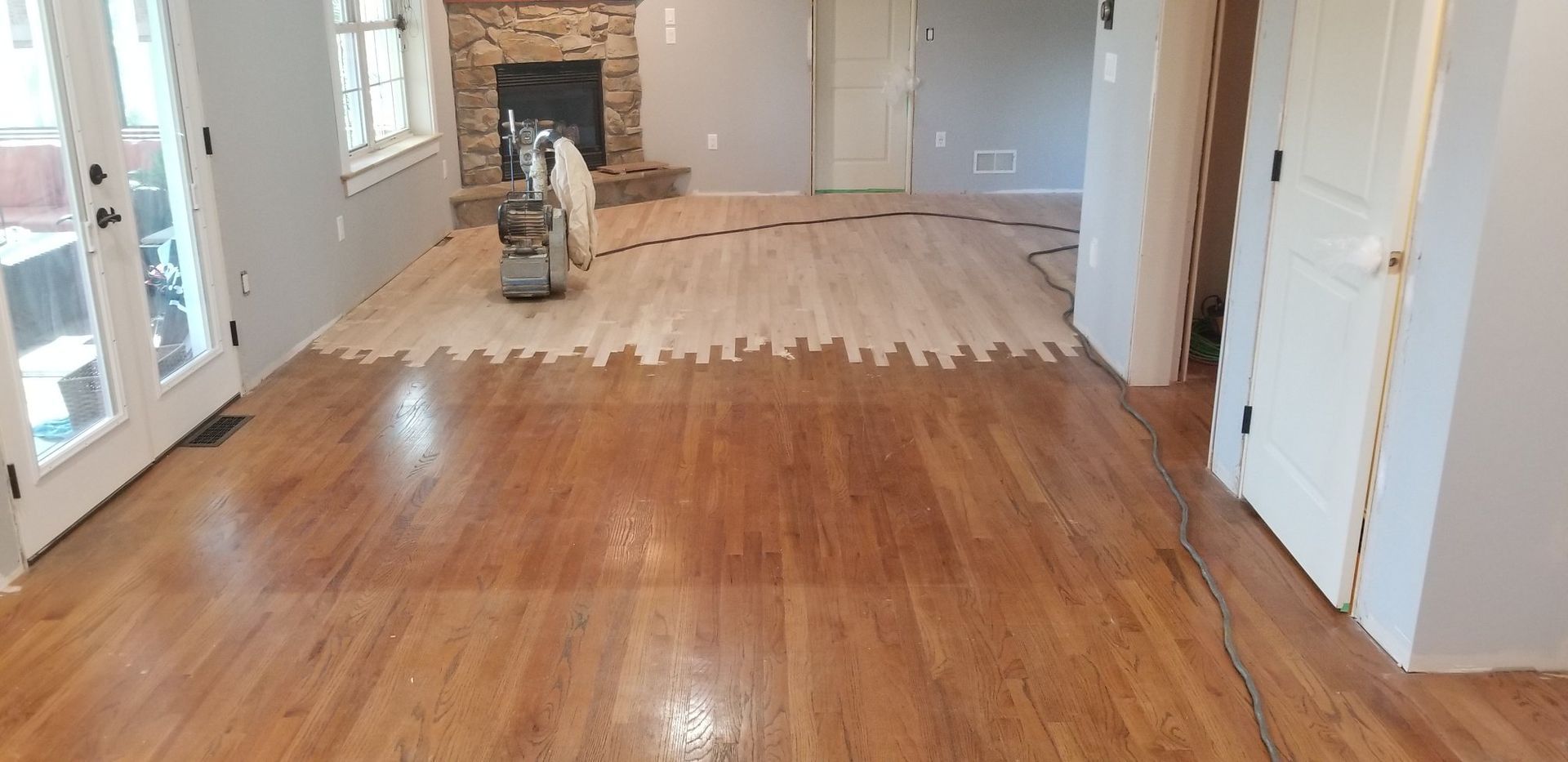 A living room with hardwood floors and a fireplace.