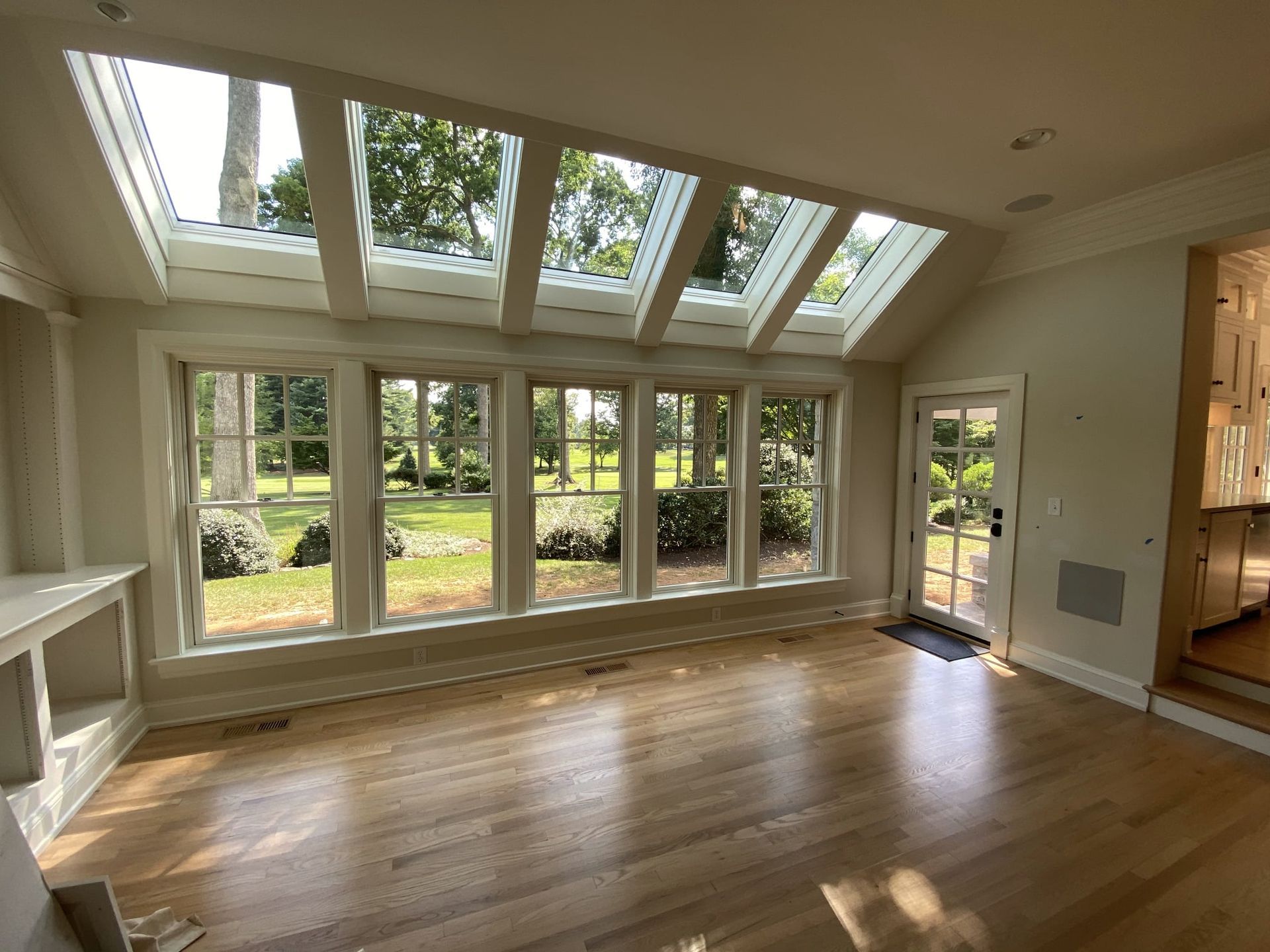 An empty room with a lot of windows and a skylight